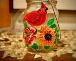 Load image into Gallery viewer, Decorative votive candle holder with oil painting. Flowers and cardinal bird oil painting by hand on mason jar. 
